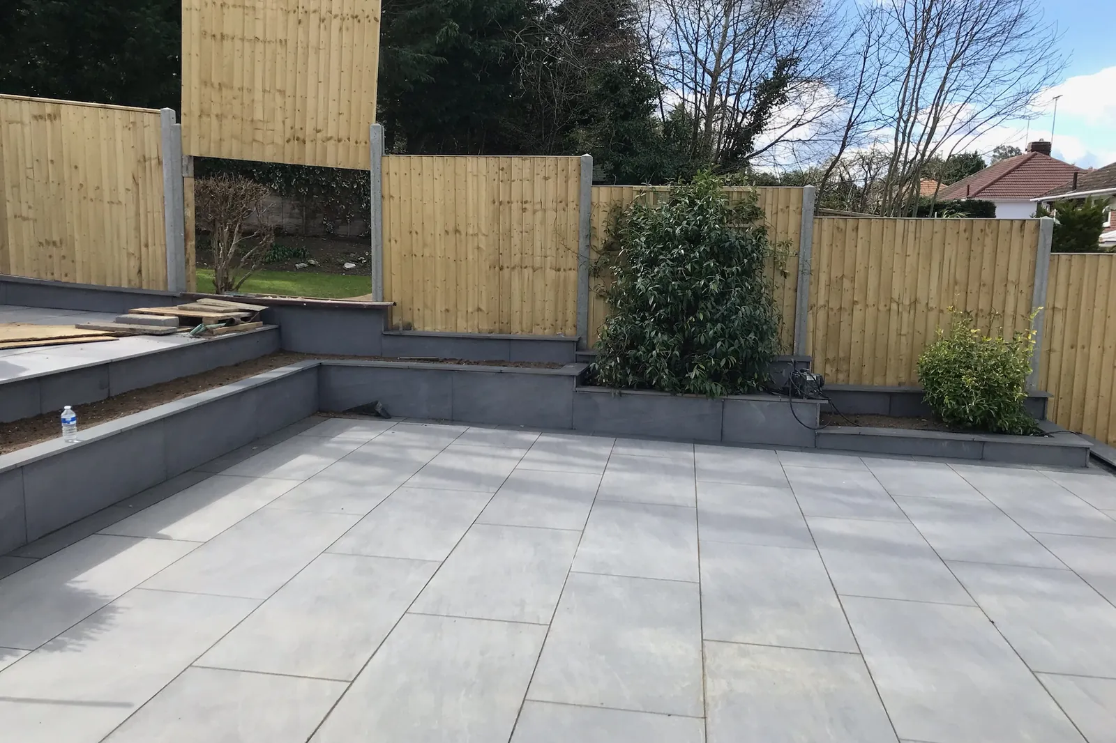 Raised block walls and steps round a porcelain patio, Tilehurst, Reading, 2022