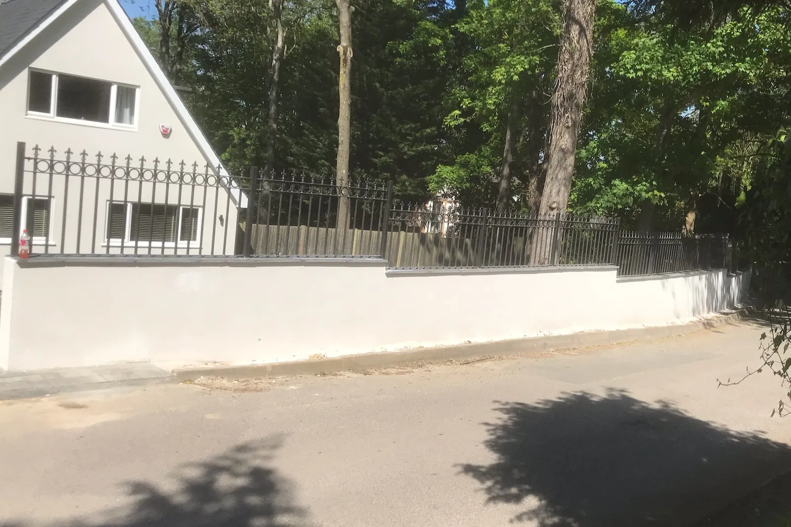 Rendered boundary wall with metal railings, Windsor, 2020