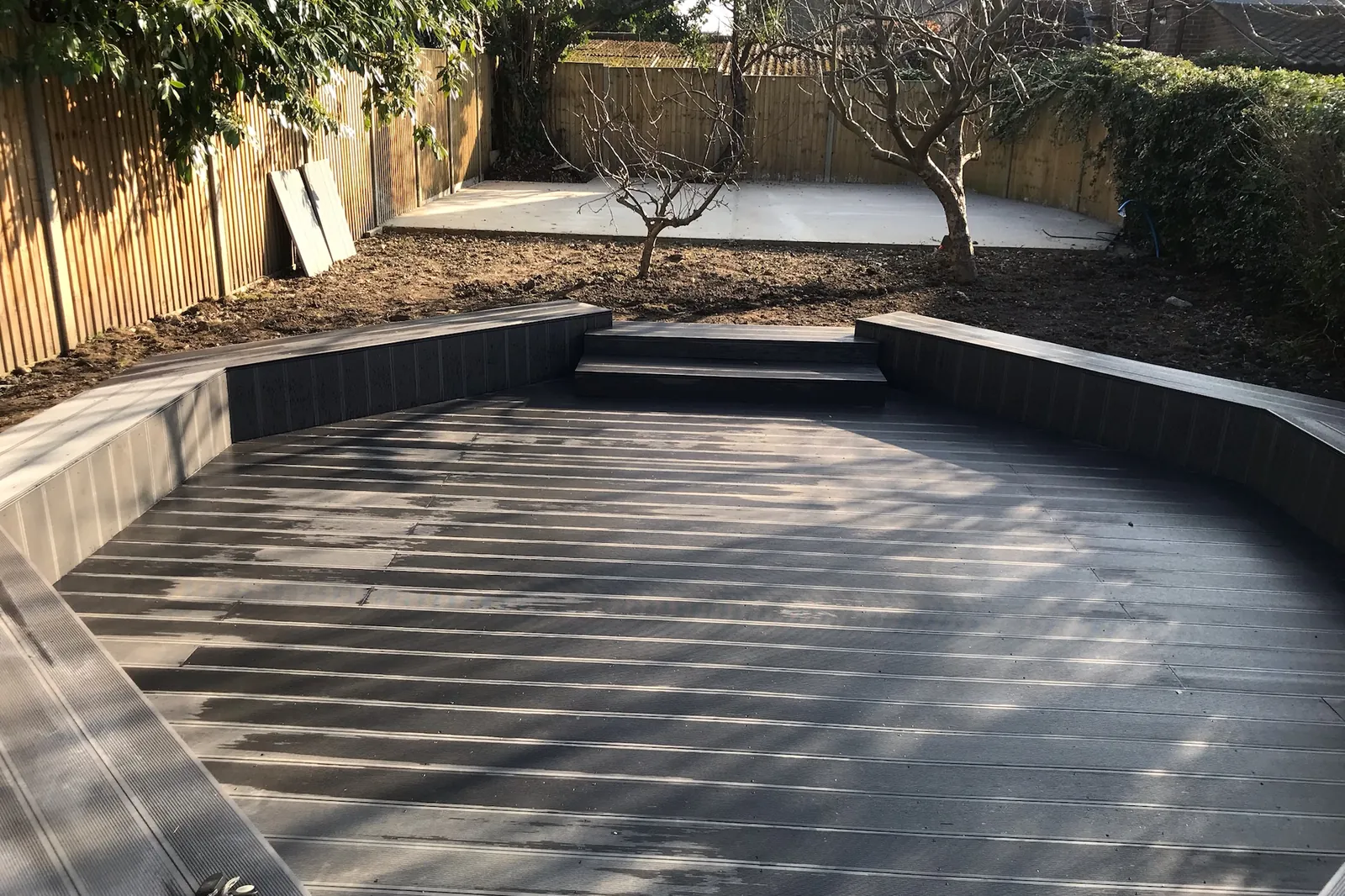 Composite deck with a raised bench edge and steps, Farnham Royal, Slough, 2021