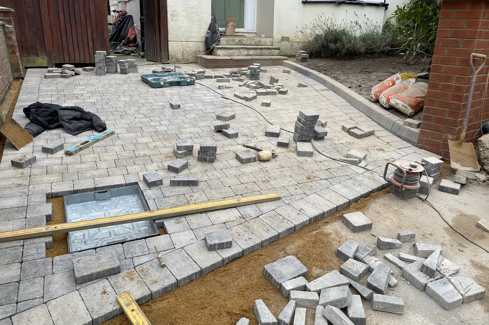 Block paving going down, the cuts still to do, Maidenhead, 2024