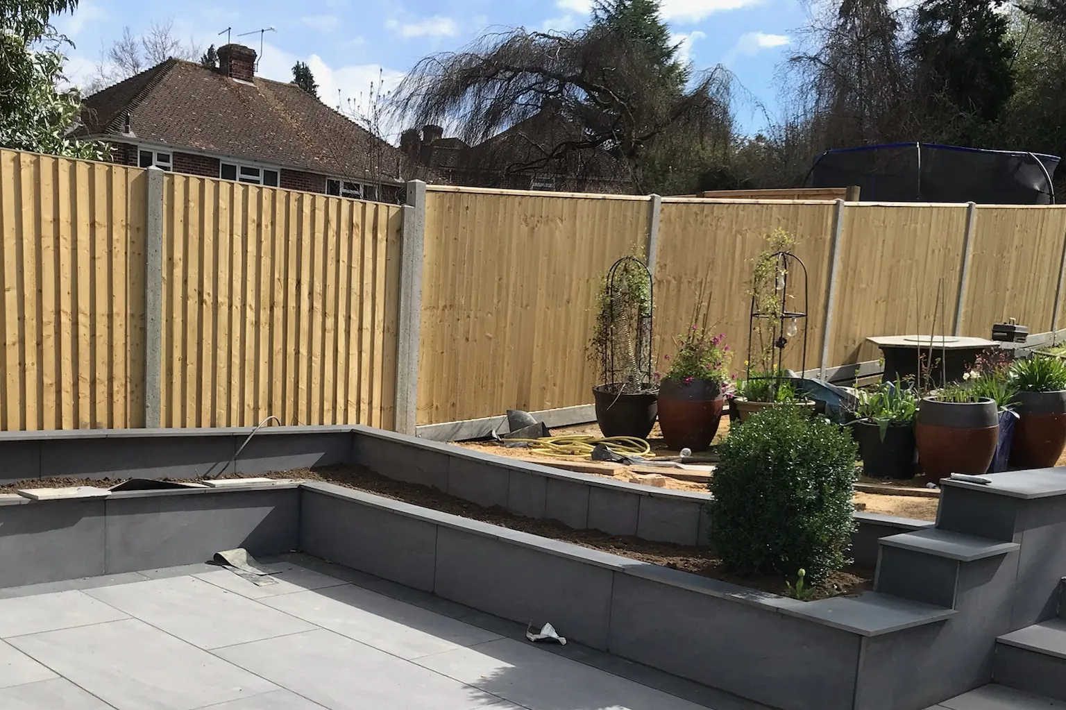 Feather-edge fencing along a new porcelain patio, Tilehurst, Reading, 2022