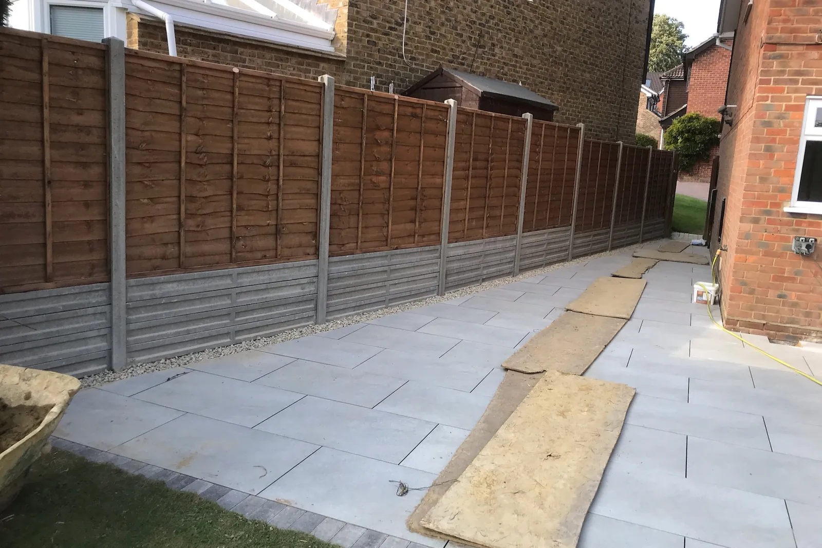 Fence panels on concrete posts and gravel boards along a new patio, Wokingham, 2020