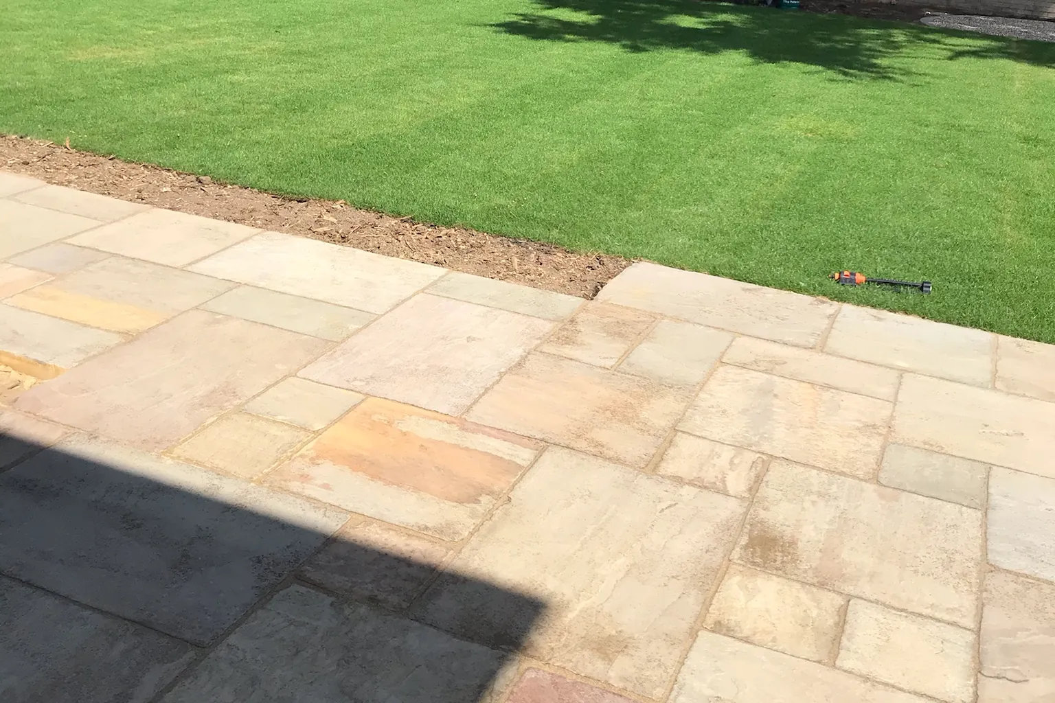 Indian sandstone patio laid to the edge of a new lawn, Farnham Royal, Slough, 2020