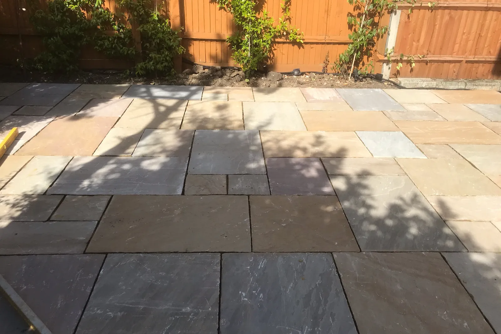 Indian sandstone patio laid along the fence, Maidenhead, 2020
