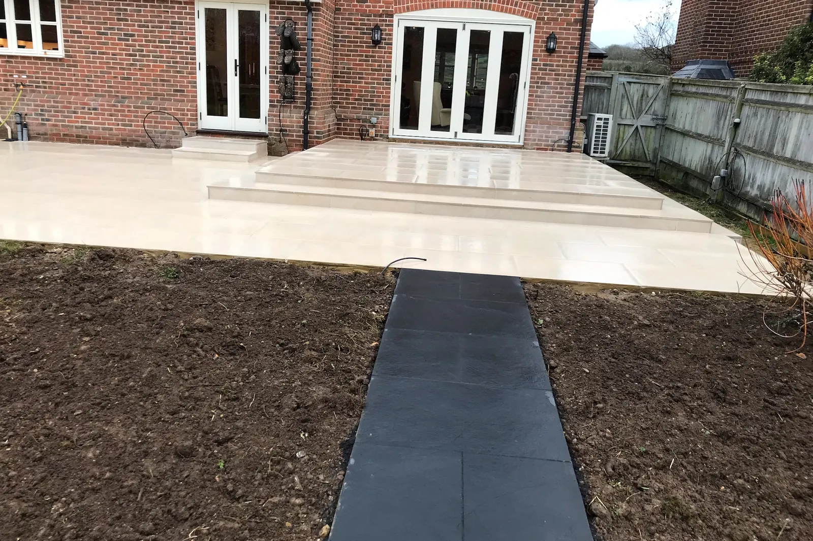 Porcelain patio and steps, with a black slate path through new beds, Marlow, 2021