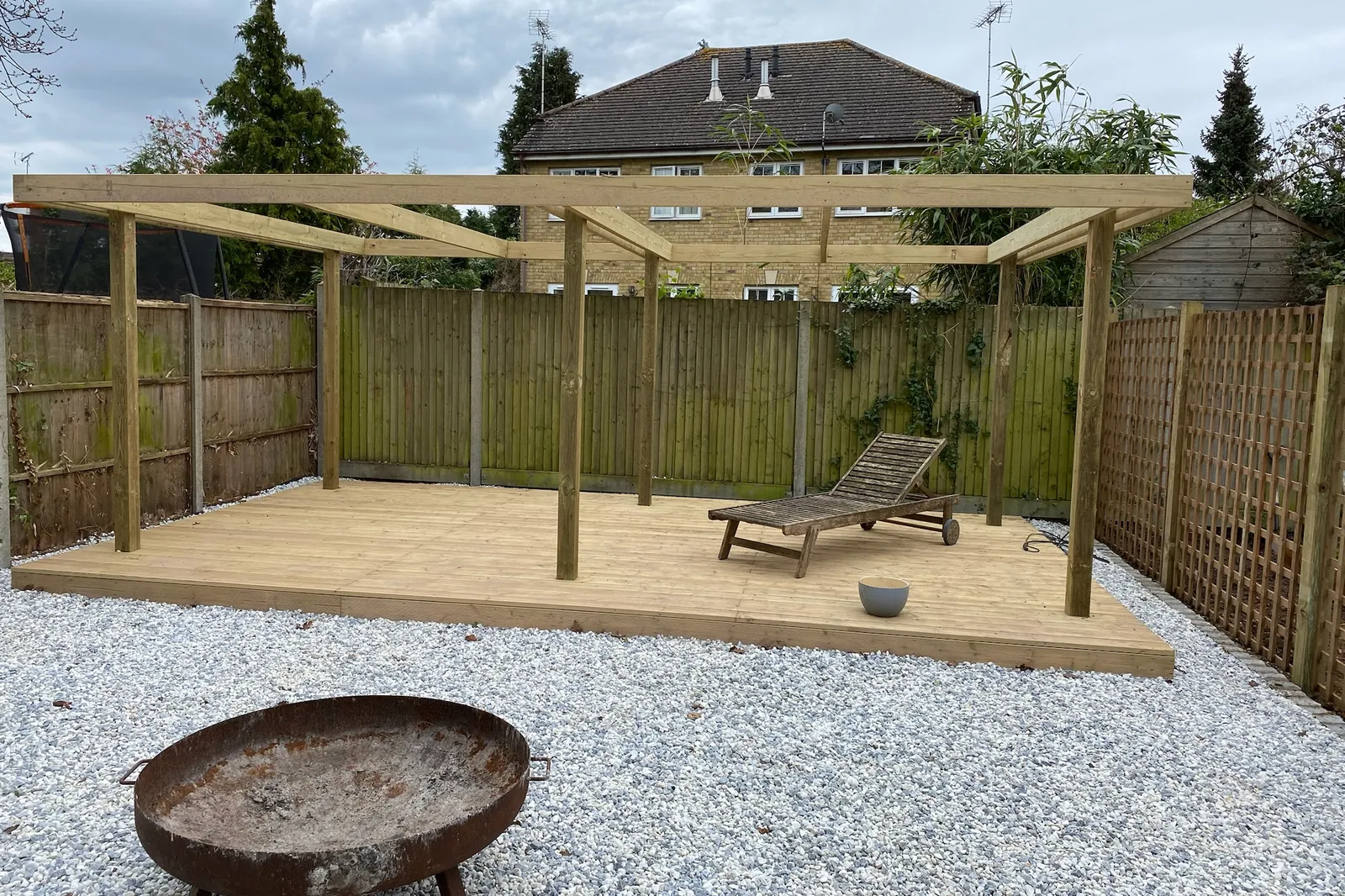 Timber pergola and deck in a gravel garden with a fire bowl, Earley, Reading, 2024