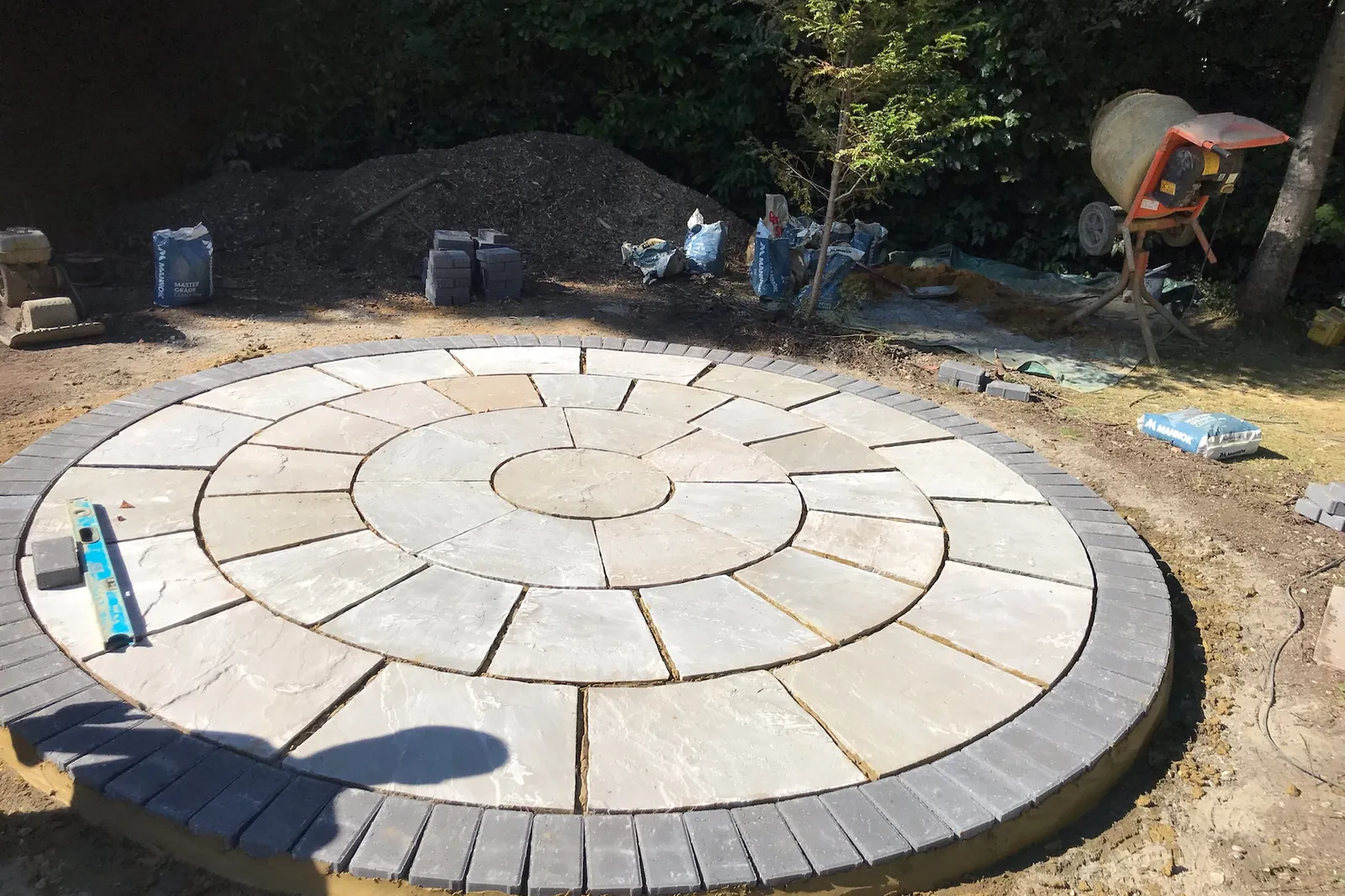 Circular sandstone base with a setts border, laid first, Farnham Royal, Slough, 2021