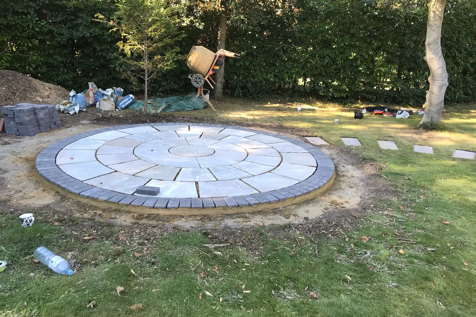 The circular sandstone base laid on the lawn, Farnham Royal, Slough, 2021
